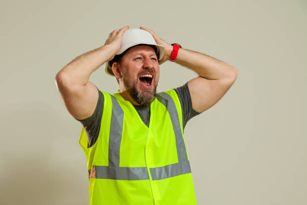 istock worker in a vest and white helmet 1452720877