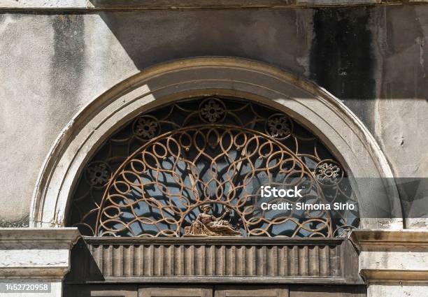 Closeup Of The Overdoor Of An Old Palace Decorated With A Wrought Iron Bezel Soave Verona Veneto Italy Stock Photo - Download Image Now