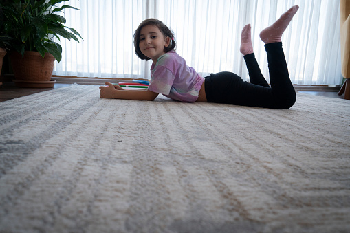 Little girl do stretching exercise in living room