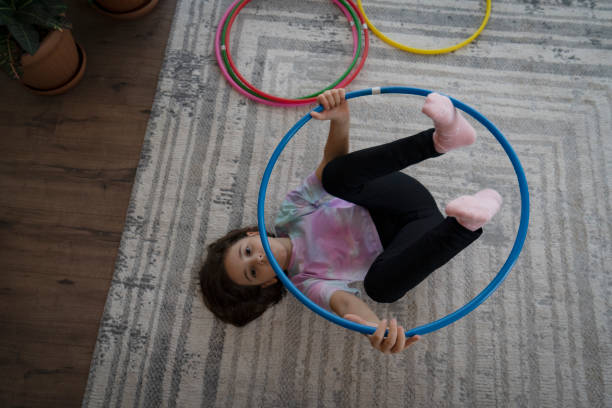 istock Little girl playing with hula hoop 1452721154