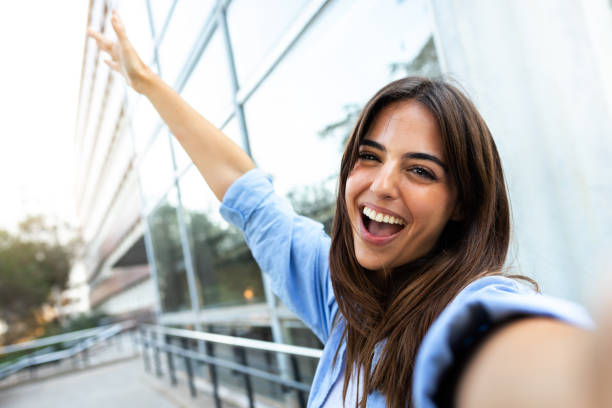 istock Young caucasian brunette woman taking selfie looking at camera. Copy space. 1452721805