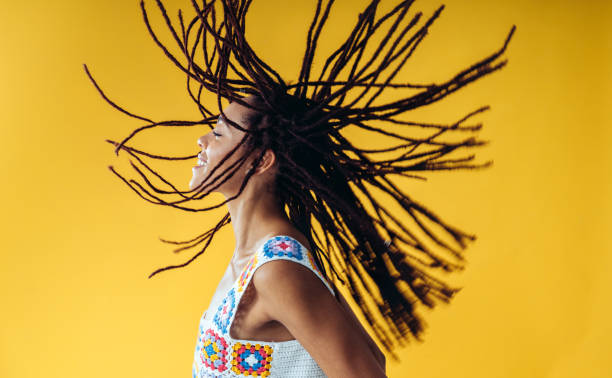 Woman posing on colored backgrounds in studio wearing trendy clothes