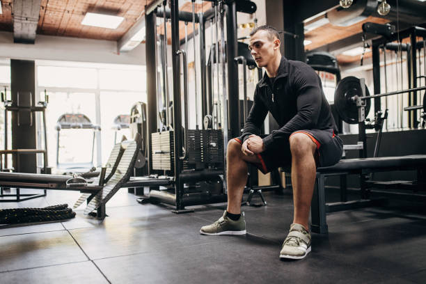 istock Young man sitting in gym 1452723896