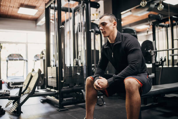 istock Young man sitting in gym 1452723972
