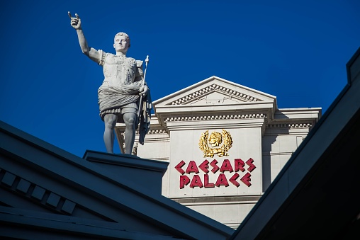 Las Vegas, United States – October 15, 2021: A view from the strip of Caesars Palace in Las Vegas with a statue and signage against a blue sky