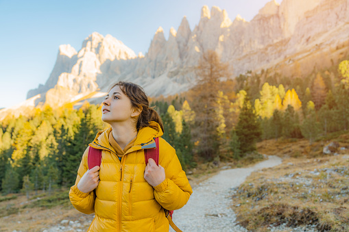Young Caucasian woman hiking in Dolomites  in autumn