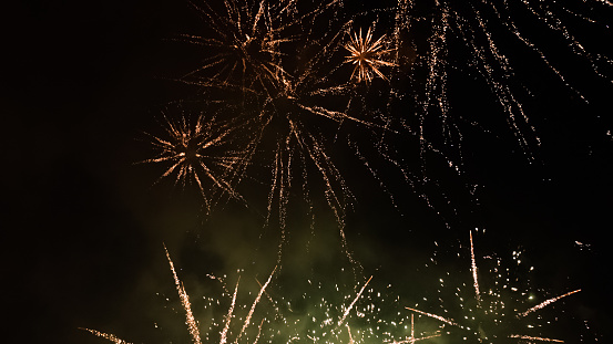 Salute in the night sky. Bright texture of festive fireworks. Abstract holiday background with various colors fireworks light. New Year's, Christmas lights in the sky, colorful lights.