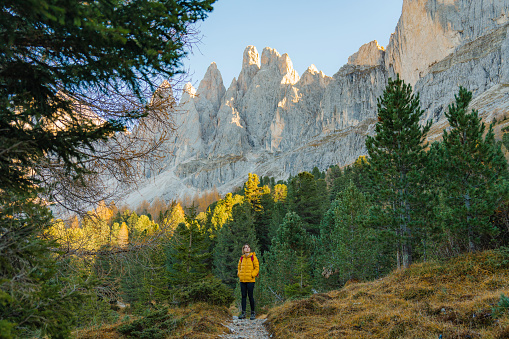 Young Caucasian woman hiking in Dolomites  in autumn