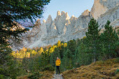 Woman hiking  in Dolomites  in autumn