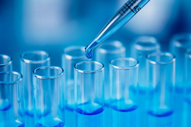 istock Test tubes with blue liquid water samples and pipette over blue background. 1452726478