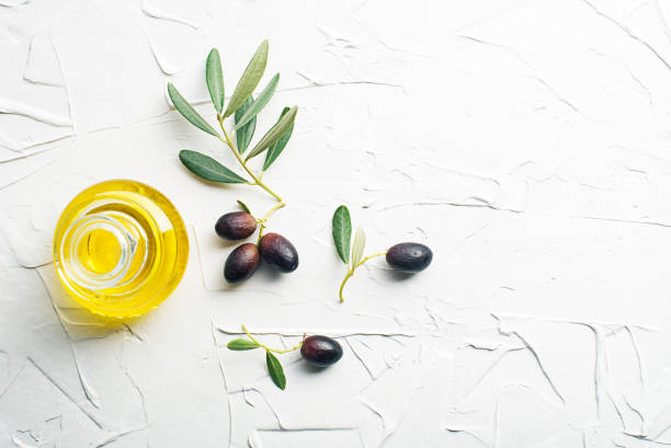 istock Olive oil background with bottle ad branch 1452727812