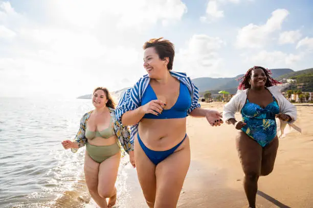 Photo of Group of plus size women with swimwear at the beach