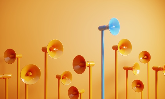 Orange colored megaphones, blue one on the top, can be used leadership/individuality concepts. (3d render)