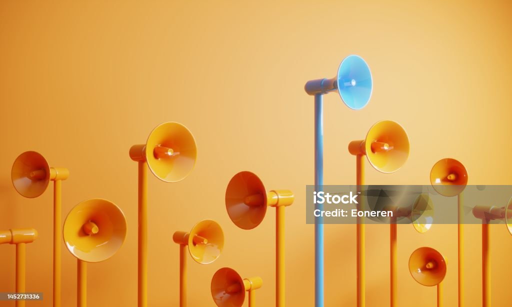 Blue colored megaphone standing out from the crowd Orange colored megaphones, blue one on the top, can be used leadership/individuality concepts. (3d render) Marketing Stock Photo