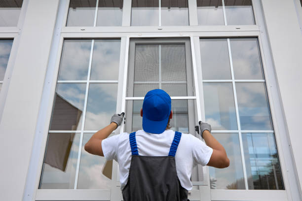 Professional installation of protective nets against insects on plastic windows Experienced worker holds mosquito net in his hands, professionally installs it on window outside building. Professional installation of protective nets against insects on plastic windows of any size installing stock pictures, royalty-free photos & images