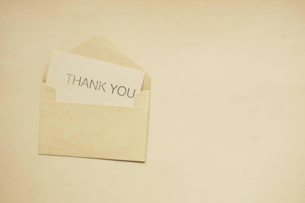 istock thank you message and envelope on wooden table 1452733546