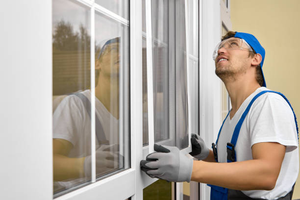 istock Worker in overalls and goggles looks up with smile when installing mosquito net 1452733614