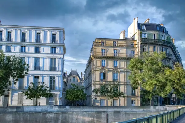 Paris, ile saint-louis and quai de Bethune, beautiful ancient buildings, blue hour on the Sully bridge