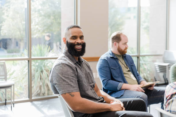 istock Cheerful man smiles for camera during meeting 1452736799