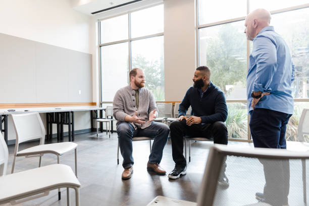 istock Mature counselor listens in on conversation between two men 1452736826
