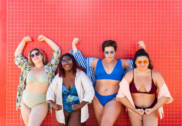 Group of plus size women with swimwear at the beach stock photo