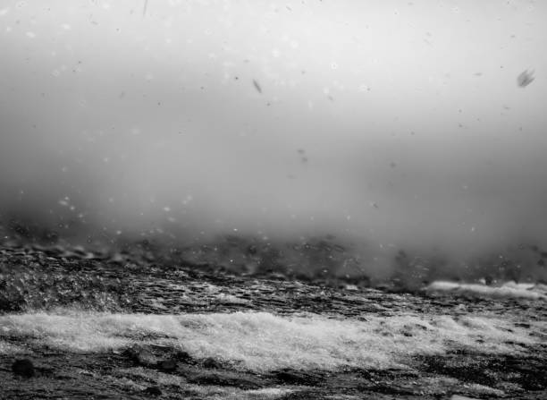 Photo stacked ground level view of ice accumulation on a sidewalk with snow blowing in the air. High quality photo