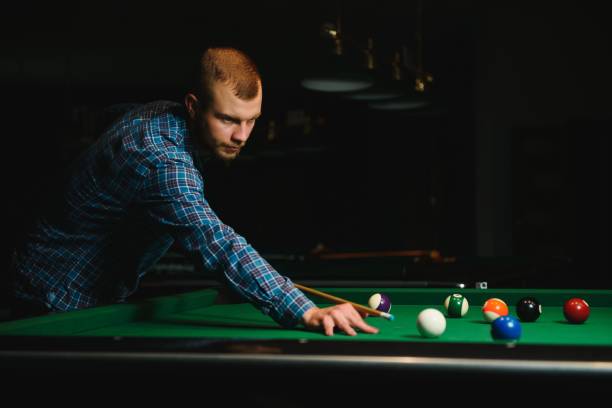 istock Man playing billiards in a club 1452739855