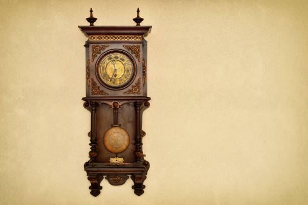 istock Old clock hanging on the grunge texture wall 1452744861
