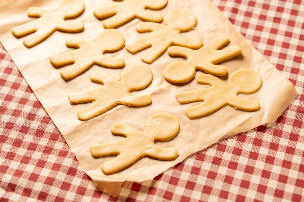 Cooking gingerbread man cookies. Cookie blanks are on the table and ready to bake.