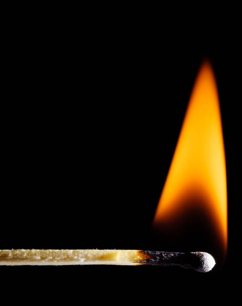 istock A lit wooden match burns with an orange flame against a black 1452746260