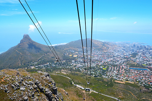 Cape Town, South Africa - January 14, 2019: View from Table Mountain National Park to Lions Head Peak, Cape Town and Robben Island. Under the massive wires of the cable car. South Africa.