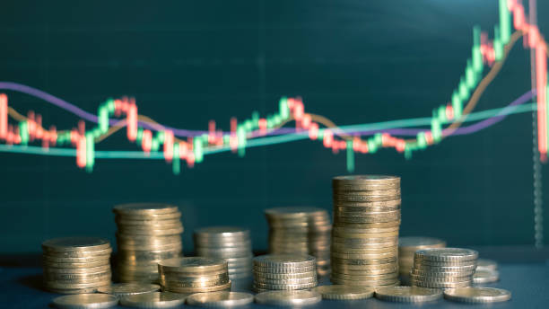 istock Stock market chart behind pile of coins 1452748607
