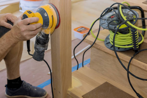 istock In a new home, carpenter polished using a polishing machine in order to refinish railings frames trim 1452748886
