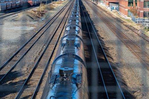 December 16, 2022 - A long line of black liquid container train cars on the Downtown Seattle train tracks.