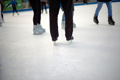 Toronto, Ontario, Canada- December 20th, 2022: People ice skating at Toronto City Hall’s Nathan Phillips Square.