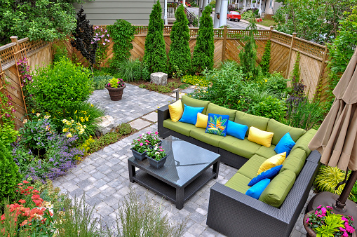 Plastic room installed in outdoor garden, ornamental detail in space covered by grass and old trees.