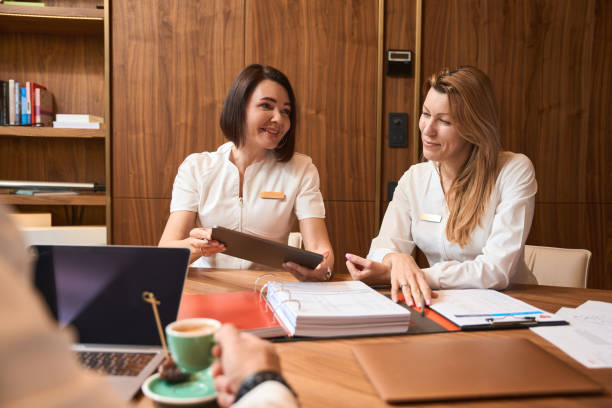 istock Women doctors are sitting at a table with a laptop 1452752906