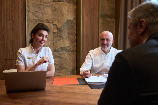istock Doctors and client are sitting at a desk and talking 1452752972