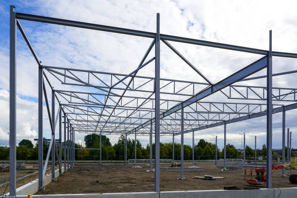 istock Assembled steel framework of new modern industrial building with foundation concrete panel border 1452754006