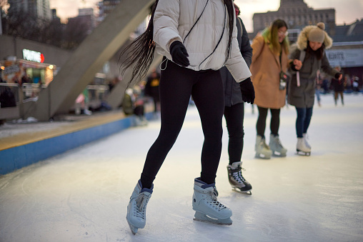 Toronto, Ontario, Canada- December 14th, 2022: People ice skating at Toronto City Hall’s Nathan Phillips Square.