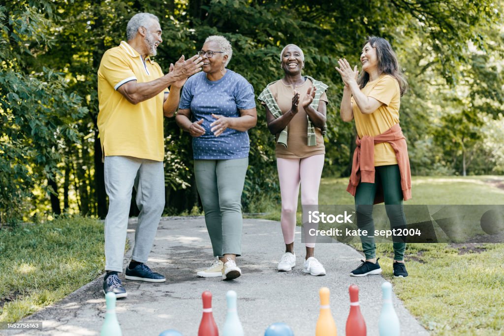 A focus on loved once Group of seniors friends exercising in the park 60-64 Years Stock Photo