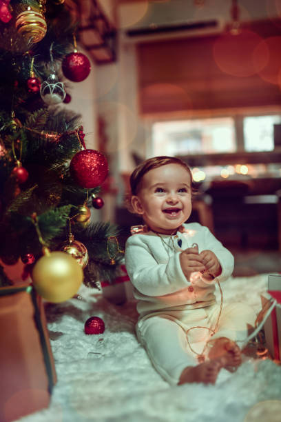 istock Baby Boy Laughing With Happiness At Christmas Lights 1452758421