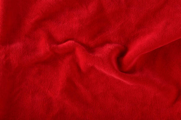 istock Red velvet texture for postcard or background for design. Red background for Christmas theme or Valentine's day, high quality, large format. Abstract texture of draped red velvet 1452758576