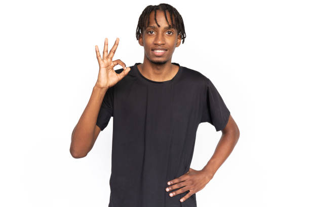 istock Satisfied young man showing OK gesture 1452759812