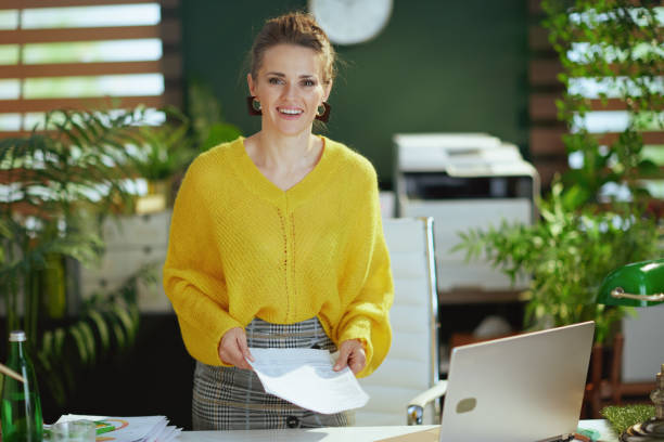 istock business owner woman in green office working with documents 1452759950