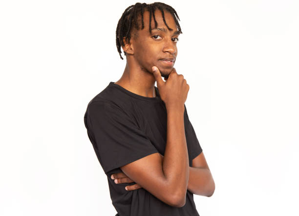 istock Pensive young man holding finger on his chin 1452760609