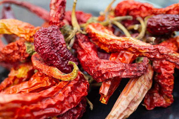 istock Dried red and orange chilli peppers, soft focus close up 1452760795