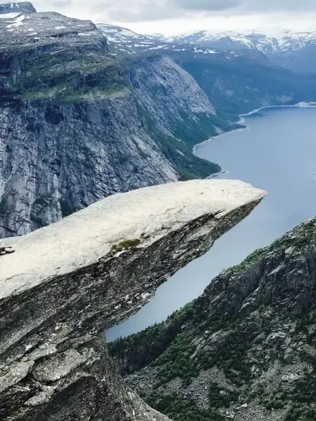 Photo of Vertical shot of the Trolltunga rock formation in Norway.