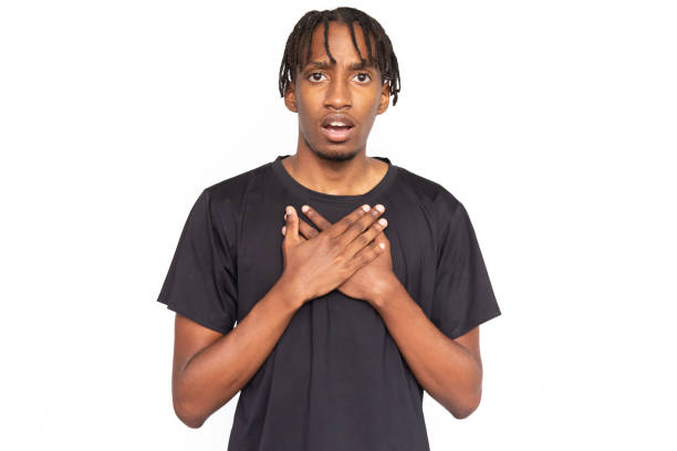 istock Astonished young man holding hands on his chest from shock 1452761933