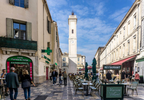 Dining out and street life in Place de l’Horloge, Nimes, France